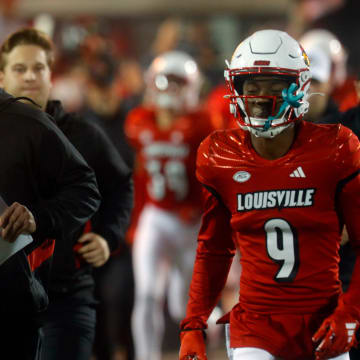 Louisville's Jeff Brohm comes out onto the field against Notre Dame at L&N Stadium.