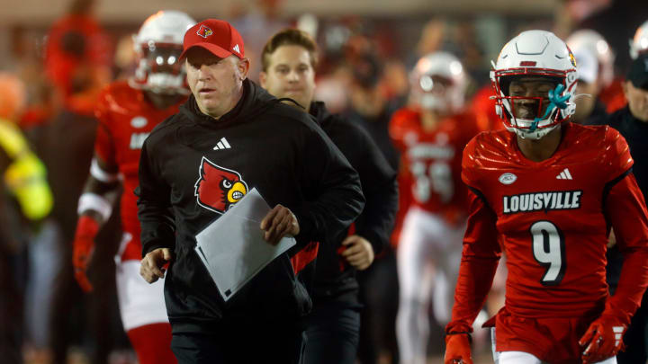 Louisville's Jeff Brohm comes out onto the field against Notre Dame at L&N Stadium.