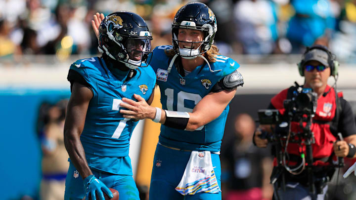 Jacksonville Jaguars quarterback Trevor Lawrence (16) congratulates wide receiver Brian Thomas Jr. (7) on his touchdown score during the third quarter of an NFL football matchup Sunday, Oct. 27, 2024 at EverBank Stadium in Jacksonville, Fla. The Packers edged the Jaguars 30-27 on a last-second field goal. [Corey Perrine/Florida Times-Union]