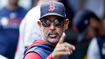 Boston Red Sox manager Alex Cora (13) stands in the dugout following the inning against the Seattle Mariners at T-Mobile Park.