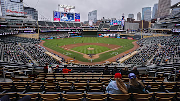 Jun 26, 2025; Minneapolis, Minnesota, USA; Sparsely seated fans watch the Seattle Mariners play the Minnesota Twins in the seventh inning after a nearly four and a half hour rain delay at Target Field. Mandatory Credit: Bruce Kluckhohn-Imagn Images
