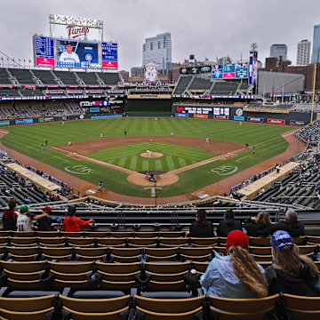 Jun 26, 2025; Minneapolis, Minnesota, USA; Sparsely seated fans watch the Seattle Mariners play the Minnesota Twins in the seventh inning after a nearly four and a half hour rain delay at Target Field. Mandatory Credit: Bruce Kluckhohn-Imagn Images