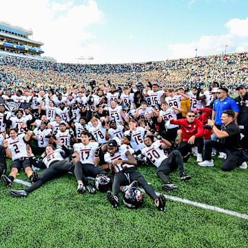 Sep 7, 2024; South Bend, Indiana, USA; The Northern Illinois Huskies pose for photos after defeating the Notre Dame Fighting Irish 16-14 at Notre Dame Stadium. Mandatory Credit: Matt Cashore-Imagn Images