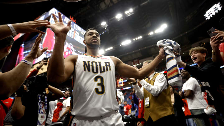 Pelicans guard CJ McCollum high fives fans after their NBA Play-In Tournament win over the San Antonio Spurs.