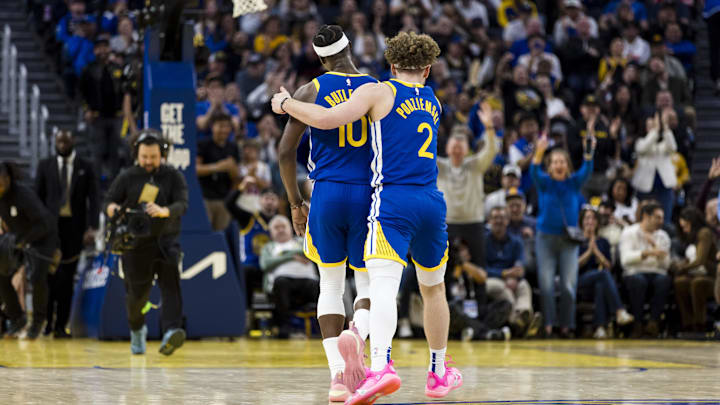 Feb 23, 2025; San Francisco, California, USA; Golden State Warriors guard Brandin Podziemski (2) and forward Jimmy Butler III (10) reacts during the fourth quarter of the game against the Dallas Mavericks at Chase Center. Mandatory Credit: John Hefti-Imagn Images