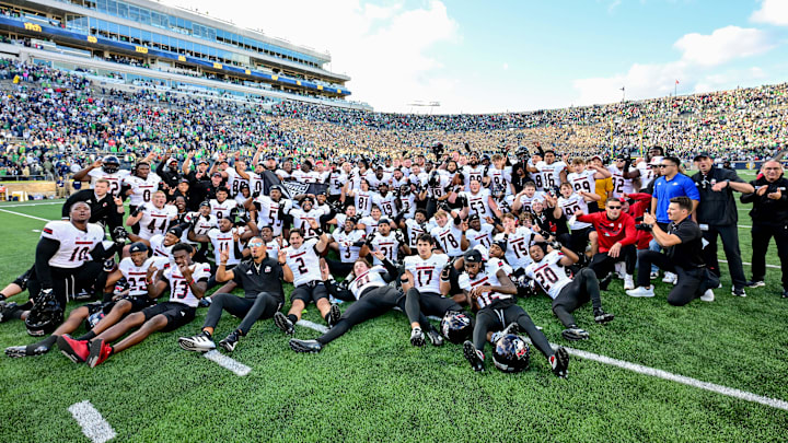 Sep 7, 2024; South Bend, Indiana, USA; The Northern Illinois Huskies pose for photos after defeating the Notre Dame Fighting Irish 16-14 at Notre Dame Stadium. Mandatory Credit: Matt Cashore-Imagn Images