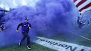 Oct 18, 2025; Evanston, Illinois, USA; Northwestern Wildcats head coach David Braun runs on the field before the game against the Purdue Boilermakers at Northwestern Medicine Field at Martin Stadium. Mandatory Credit: David Banks-Imagn Images