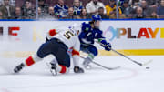 Dec 12, 2024; Vancouver, British Columbia, CAN; Florida Panthers defenseman Aaron Ekblad (5) defends against Vancouver Canucks defenseman Quinn Hughes (43) during the second period at Rogers Arena. Mandatory Credit: Bob Frid-Imagn Images