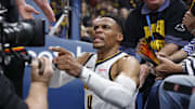 May 7, 2025; Oklahoma City, Oklahoma, USA; Denver Nuggets guard Russell Westbrook (4) reacts after a play and falling into fans in the second quarter against the Oklahoma City Thunder during game two of the second round for the 2025 NBA Playoffs at Paycom Center. Mandatory Credit: Alonzo Adams-Imagn Images