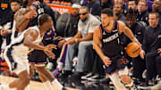 Nov 2, 2025; Phoenix, Arizona, USA; Phoenix Suns guard Devin Booker (1) drives against San Antonio Spurs forward Harrison Barnes (40) during the first half at PHX Arena. Mandatory Credit: Allan Henry-Imagn Images