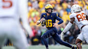 Michigan quarterback Davis Warren (16) looks to makes a pass against Texas linebacker Barryn Sorrell (88) during the second half at Michigan Stadium in Ann Arbor on Saturday, September 7, 2024.