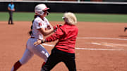 Nebraska shortstop Ava Kuszak is congraluted by coach Rhonda Revelle as she rounds the bases after a walk-off home run against Maryland Sunday at Bolwin Stadium.