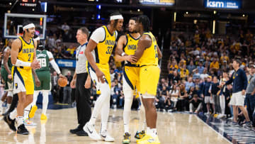 Apr 28, 2024; Indianapolis, Indiana, USA; Indiana Pacers guard Tyrese Haliburton (0) and center Myles Turner (33) hold back forward Aaron Nesmith (23) after a hard foul during game four of the first round for the 2024 NBA playoffs against the Milwaukee Bucks at Gainbridge Fieldhouse. Mandatory Credit: Trevor Ruszkowski-USA TODAY Sports