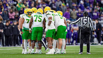 Oregon huddles up as the Oregon Ducks take on the Washington Huskies on Nov. 29, 2025, at Husky Stadium in Seattle, Washington.