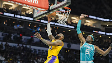Jan 27, 2025; Charlotte, North Carolina, USA;  Los Angeles Lakers forward LeBron James (23) makes a layup past Charlotte Hornets center Mark Williams (5) during the first quarter at the Spectrum Center. Mandatory Credit: Jim Dedmon-Imagn Images