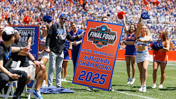 Apr 12, 2025; Gainesville, FL, USA; Florida Gators head coach Todd Golden holds the new National Championship banner during the National Championship celebration at Ben Hill Griffin Stadium. Mandatory Credit: Matt Pendleton-Imagn Images