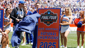 Apr 12, 2025; Gainesville, FL, USA; Florida Gators head coach Todd Golden unveals the National Championship banner during the National Championship celebration at Ben Hill Griffin Stadium. Mandatory Credit: Matt Pendleton-Imagn Images