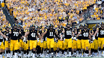 The Iowa Hawkeyes swarm onto the field before the football game against the Massachusetts Minutemen Sept. 13, 2025 at Kinnick Stadium in Iowa City, Iowa.