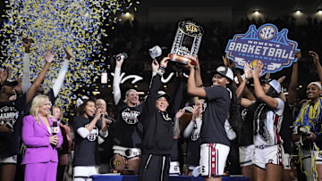 March 9, 2025; Greenville, SC, USA; South Carolina Gamecocks head coach Dawn Staley hoists the SEC Championship Trophy after her teams win over Texas during the SEC Women’s Tournament at Bon Secours Wellness Arena. Mandatory Credit: Jim Dedmon-Imagn Images