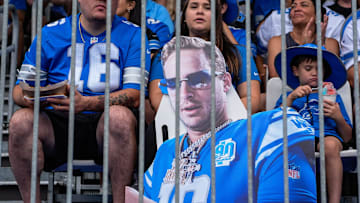 Detroit Lions fans with quarterback Jared Goff cut out watch practice during training camp at Meijer Performance Center in Allen Park on Saturday, July 26, 2025.