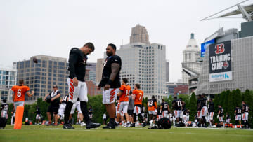 Aug 9, 2023; Cincinnati, OH, USA; Cincinnati Bengals defensive end Trey Hendrickson (91), left, and Cincinnati Bengals defensive tackle Josh Tupou (68), right, talk as the team stretches during a joint practice between the Green Bay Packers and the Cincinnati Bengals, Wednesday, Aug. 9, 2023, at the practice fields next to Paycor Stadium in Cincinnati. Mandatory Credit: Kareem Elgazzar-USA TODAY Sports 