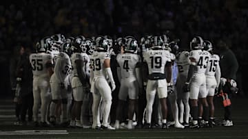 Oct 26, 2024; Ann Arbor, Michigan, USA;  Michigan State Spartans huddle up during a time out in the first half against the Michigan Wolverines at Michigan Stadium. Mandatory Credit: Rick Osentoski-Imagn Images