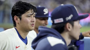 Los Angeles Dodgers designated hitter Shohei Ohtani, left, sits with starting pitcher Roki Sasaki during the ninth inning of a baseball game against the San Francisco Giants at Dodger Stadium on June 14.