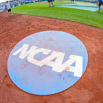 Jun 18, 2023; Omaha, NE, USA; An on-deck circle with the NCAA logo is pictured on the field before the game between the Virginia Cavaliers and the TCU Horned Frogs at Charles Schwab Field Omaha. Mandatory Credit: Dylan Widger-Imagn Images