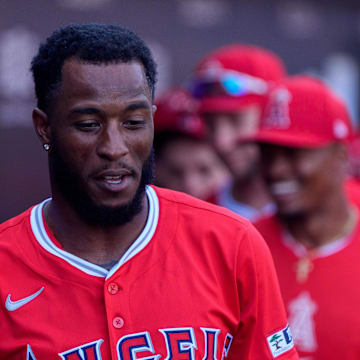 Los Angeles Angels infielder Tim Anderson (77) celebrates with his team after hitting a home run during a spring training game against the Chicago Cubs at Sloan Park. 