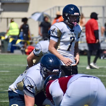 Arlington quarterback Leyton Martin throws a pass during the PLU Football Showcase in Parkland.