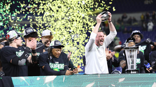 Dec 7, 2024; Indianapolis, IN, USA; Oregon Ducks head coach Dan Lanning and the Oregon Ducks celebrate defeating the Penn Sta