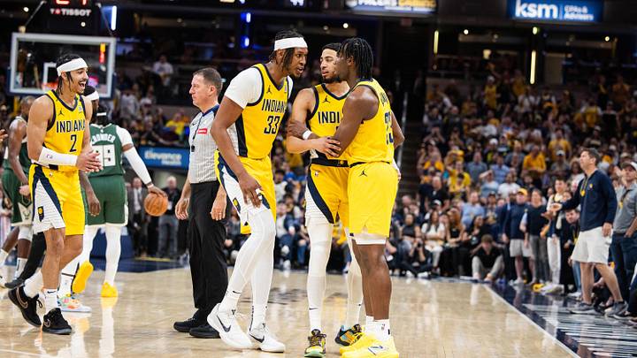 Apr 28, 2024; Indianapolis, Indiana, USA; Indiana Pacers guard Tyrese Haliburton (0) and center Myles Turner (33) hold back forward Aaron Nesmith (23) after a hard foul during game four of the first round for the 2024 NBA playoffs against the Milwaukee Bucks at Gainbridge Fieldhouse. Mandatory Credit: Trevor Ruszkowski-USA TODAY Sports