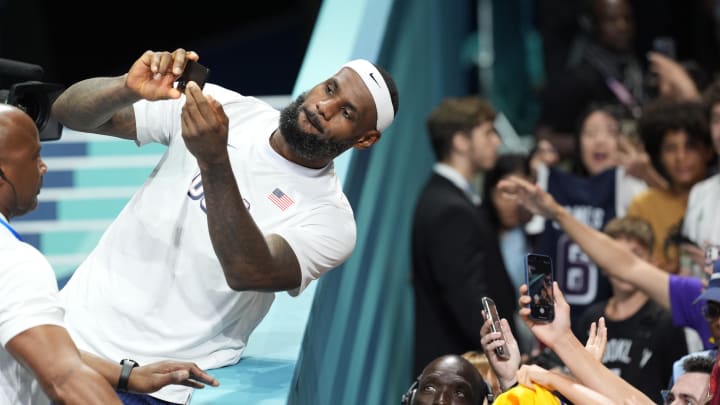 Aug 3, 2024; Villeneuve-d'Ascq, France; United States guard LeBron James (6) takes pictures after defeating Puerto Rico during the Paris 2024 Olympic Summer Games at Stade Pierre-Mauroy. Mandatory Credit: John David Mercer-USA TODAY Sports