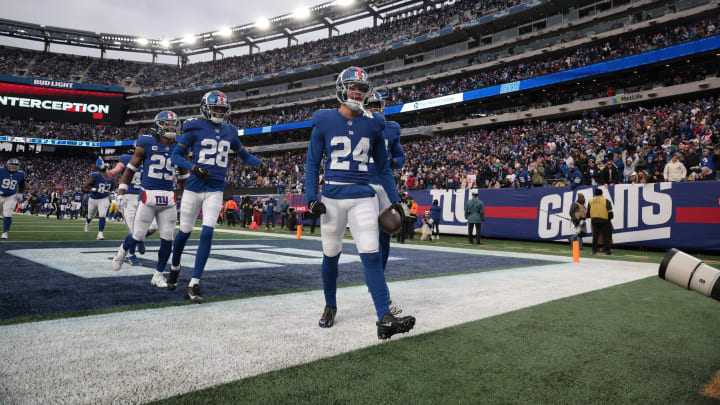 Dec 31, 2023; East Rutherford, New Jersey, USA; New York Giants safety Dane Belton (24) celebrates with teammates after an interception during the second half against the Los Angeles Rams at MetLife Stadium.  