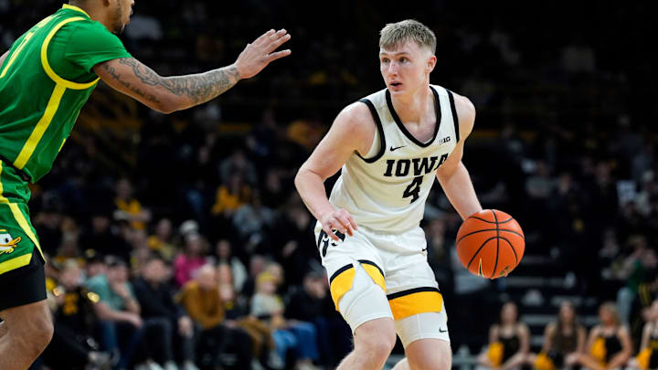 Iowa guard Josh Dix (4) is defended by Oregon guard Ra'Heim Moss (0) Wednesday, Feb. 19, 2025 at Carver-Hawkeye Arena in Iowa City, Iowa. Iowa guard Josh Dix (4) is defended by Oregon guard Ra'Heim Moss (0) Wednesday, Feb. 19, 2025 at Carver-Hawkeye Arena in Iowa City, Iowa.