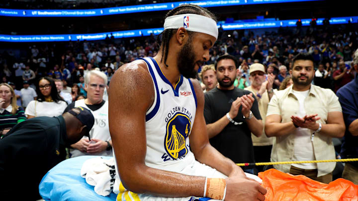 Mar 23, 2026; Dallas, Texas, USA;  Golden State Warriors guard Moses Moody (4) leaves the court on a stretcher during overtime against the Dallas Mavericks at American Airlines Center. Mandatory Credit: Kevin Jairaj-Imagn Images