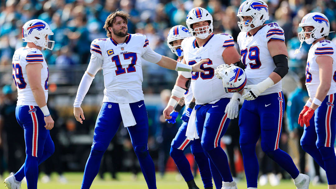 Buffalo Bills quarterback Josh Allen (17) collects his helmet from offensive tackle Spencer Brown (79) during the first quarter of an NFL football AFC Wild Card playoff matchup, Sunday, Jan. 11, 2026, in Jacksonville, Fla.