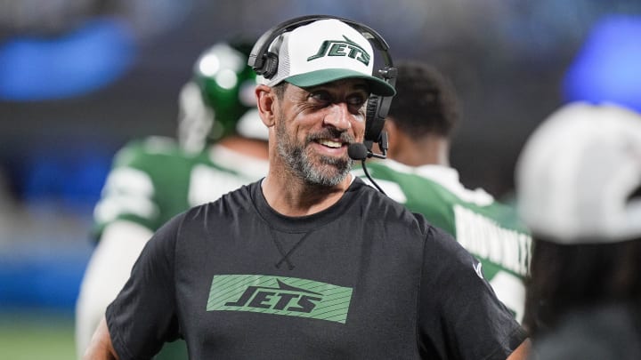 Aug 17, 2024; Charlotte, North Carolina, USA;  New York Jets quarterback Aaron Rodgers (8) shares a laugh on the sidelines during the second half against the Carolina Panthers at Bank of America Stadium. 