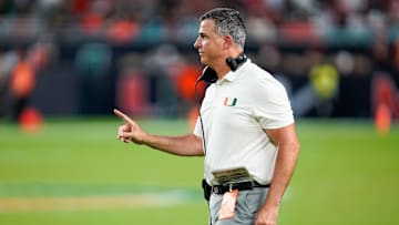 Nov 8, 2025; Miami Gardens, Florida, USA; Miami Hurricanes head coach Mario Cristobal gives his team instructions against the Syracuse Orange during the third quarter at Hard Rock Stadium. Mandatory Credit: Jeff Romance-Imagn Images