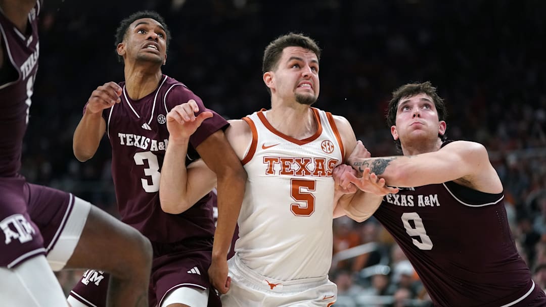 Texas A&M Aggies guard Ryan Griffen and guard Ruben Dominguez block Texas Longhorns forward Camden Heide during the second half at Moody Center. 