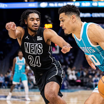 Mar 8, 2025; Charlotte, North Carolina, USA; Charlotte Hornets guard Josh Green (10) drives on Brooklyn Nets guard Cam Thomas (24) during the third quarter at Spectrum Center. Mandatory Credit: Scott Kinser-Imagn Images