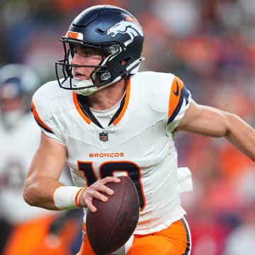 Aug 18, 2024; Denver, Colorado, USA; Denver Broncos quarterback Bo Nix (10) scrambles with the ball in the first quarter against the Green Bay Packers at Empower Field at Mile High. 