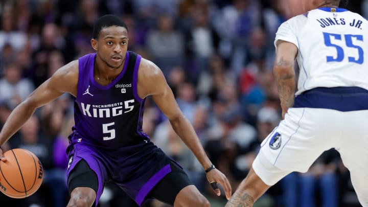 Mar 26, 2024; Sacramento, California, USA; Sacramento Kings guard De'Aaron Fox (5) dribbles the ball against Dallas Mavericks forward Derrick Jones Jr. (55) during the third quarter at Golden 1 Center. Mandatory Credit: Sergio Estrada-USA TODAY Sports