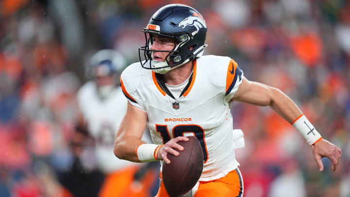 Aug 18, 2024; Denver, Colorado, USA; Denver Broncos quarterback Bo Nix (10) scrambles with the ball in the first quarter against the Green Bay Packers at Empower Field at Mile High. 