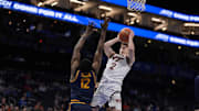 Mar 11, 2025; Charlotte, NC, USA; Virginia Tech guard Jaden Schutt (2) goes to the basket defended by California center Mady Sissoko (12).
