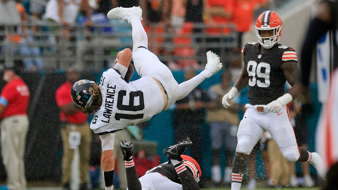 Jacksonville Jaguars quarterback Trevor Lawrence (16) is upended by Cleveland Browns linebacker Jeremiah Owusu-Koramoah (6) as defensive end Za'Darius Smith (99) looks on during the fourth quarter of an NFL football matchup Sunday, Sept. 15, 2024 at EverBank Stadium in Jacksonville, Fla. The Browns defeated the Jaguars 18-13. [Corey Perrine/Florida Times-Union]