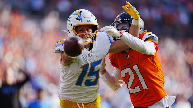 Denver Broncos cornerback Riley Moss (21) breaks up a pass to Los Angeles Chargers wide receiver Ladd McConkey (15).