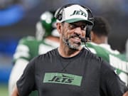 Aug 17, 2024; Charlotte, North Carolina, USA;  New York Jets quarterback Aaron Rodgers (8) shares a laugh on the sidelines during the second half against the Carolina Panthers at Bank of America Stadium. Mandatory Credit: Jim Dedmon-Imagn Images