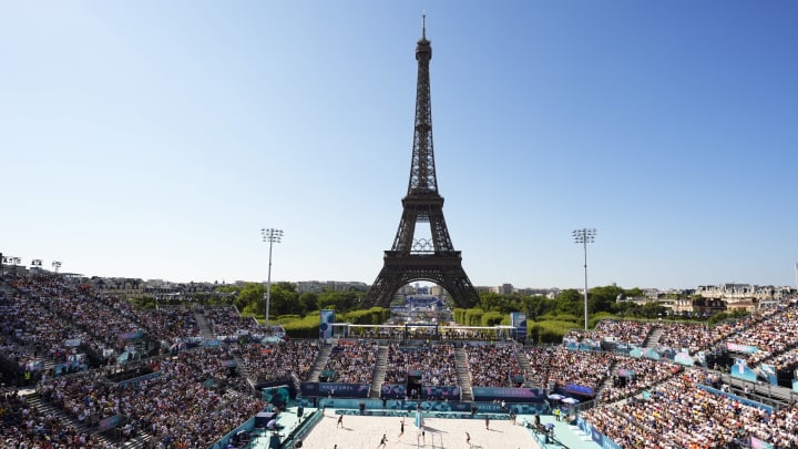 Aug 5, 2024; Paris, France; A general view of the Eiffel Tower as Miles Partain (USA) and Andrew Benesh (USA) compete against Samuele Cottafava (ITA) and Paolo Nicolai (ITA) in a beach volleyball round of 16 match during the Paris 2024 Olympic Summer Games at Eiffel Tower Stadium.