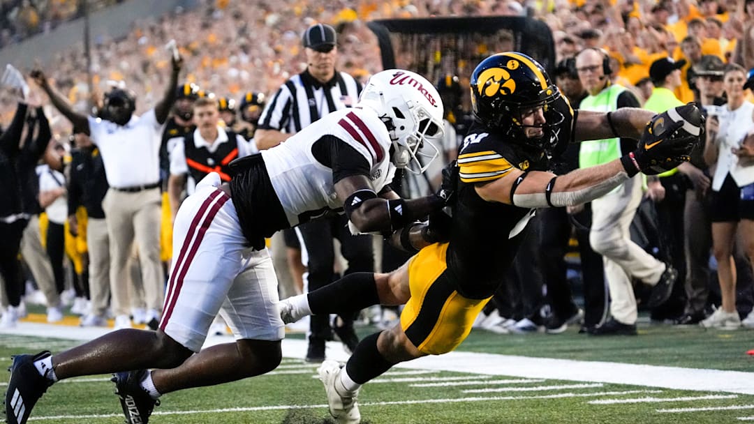 DUPLICATE***Iowa Hawkeyes wide receiver Kaden Wetjen (21) dives into the endzone to score as Massachusetts Minutemen safety DD Snyder (4) defends Sept. 13, 2025 at Kinnick Stadium in Iowa City, Iowa.